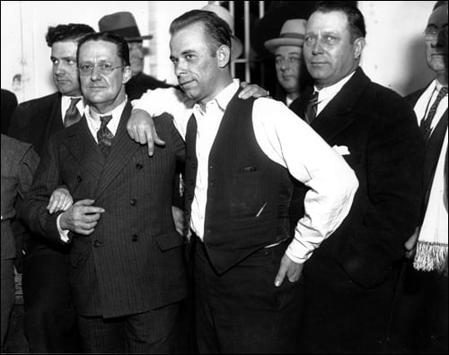 This photograph and similar ones taken that day helped lead to the firing of Lake County prosecutor Robert Estill (to Dillinger's left) and the sheriff (not pictured, but her arm is holding Estill's).