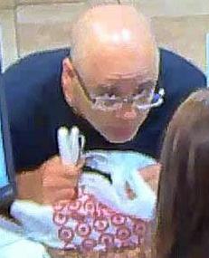A balding bank robber wearing glasses and carrying a Target plastic shopping bag is being sought by the San Diego Police Department and the FBI.