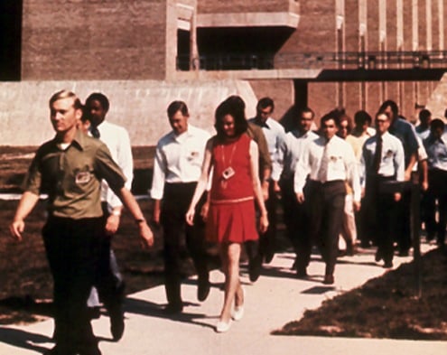 In May 1972, the FBI began accepting applications from women for the special agent position. On July 17 of that year, Joanne Pierce (Misko)—in the foreground in the red dress—and Susan Roley (Malone)—partially visible near the back of the group—were sworn in as the first two women special agents in modern times.