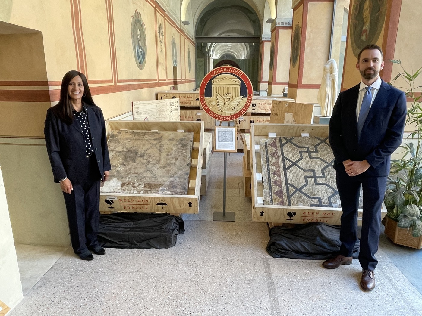 FBI art crime investigators pose with pieces of a 2,000-year-old Italian mosaic that they helped return to the country.