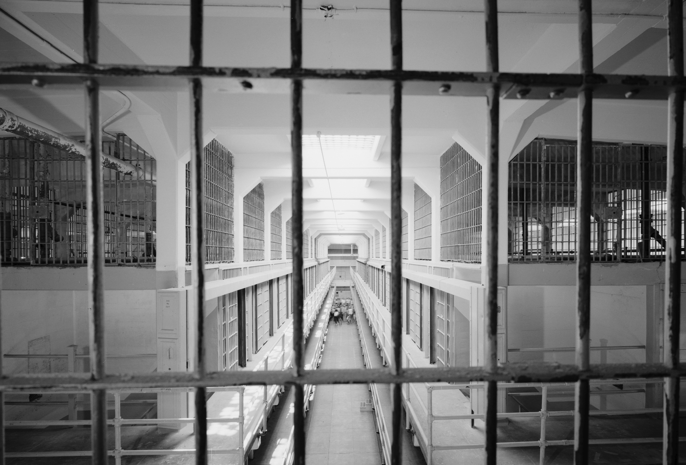 View of the interior of the Alcatraz Island prison in 1986, looking south from the third level guard station with cell block B on the left and cell block C on the right. The island was used as a maximum security federal prison from 1934 to 1963. It housed such notorious criminals as Al Capone, George "Machine Gun" Kelly, Alvin "Creepy" Karpis, Arthur "Doc" Barker, and Whitey Bulger. The FBI helped investigate a famous unsolved escape there in June 1962. Library of Congress photograph.