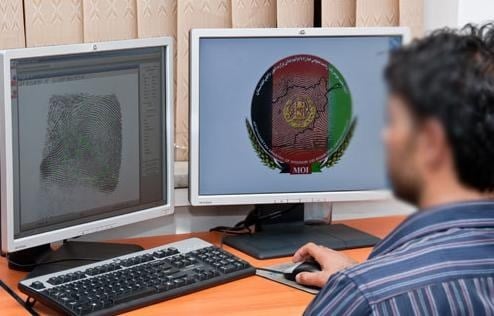 At the biometrics offices, three shifts of examiners catalog and check fingerprints on large computer screens, while technicians prepare ajump kitsaalaptop computers, scanners, and other equipment used in the field to collect fingerprints, facial images, and iris scans. 
