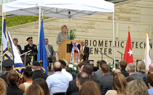 Executive Assistant Director Amy Hess, with FBI and Department of Defense officials, addresses assembled guests at the August 11, 2015 dedication of the new FBI-DOD Biometric Technology Center located in Clarksburg, West Virginia.