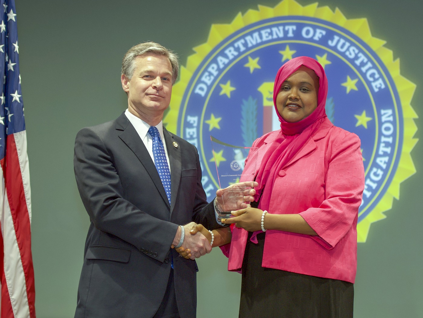 FBI Director Christopher Wray presents Boston Division recipient Deeqo Jibril with the Director’s Community Leadership Award (DCLA) at a ceremony at FBI Headquarters on May 3, 2019.