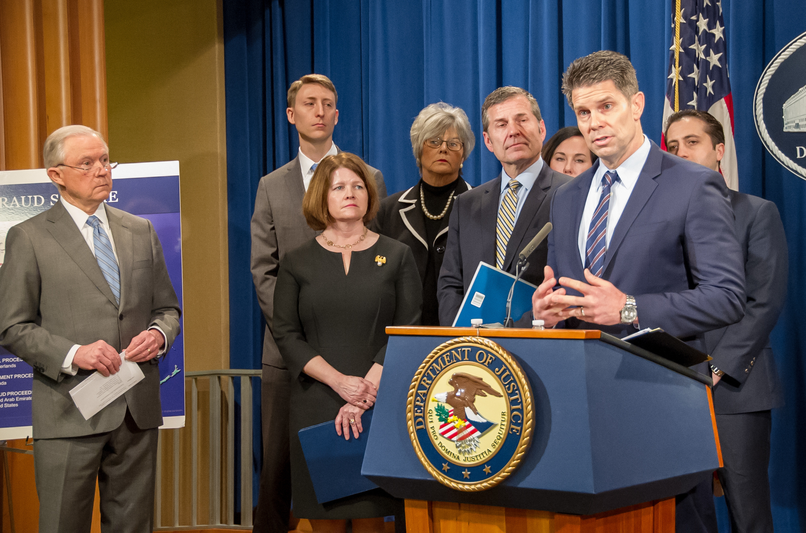 FBI Acting Deputy Director David Bowdich speaks at a February 22, 2018 press conference announcing elder fraud charges as Attorney General Jeff Sessions and others look on.