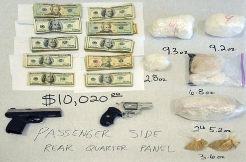 The cash, weapons, and drugs seized from a hidden compartment in the so-called “trap car” used by California drug trafficker and gang leader Luis Manual Tapia.