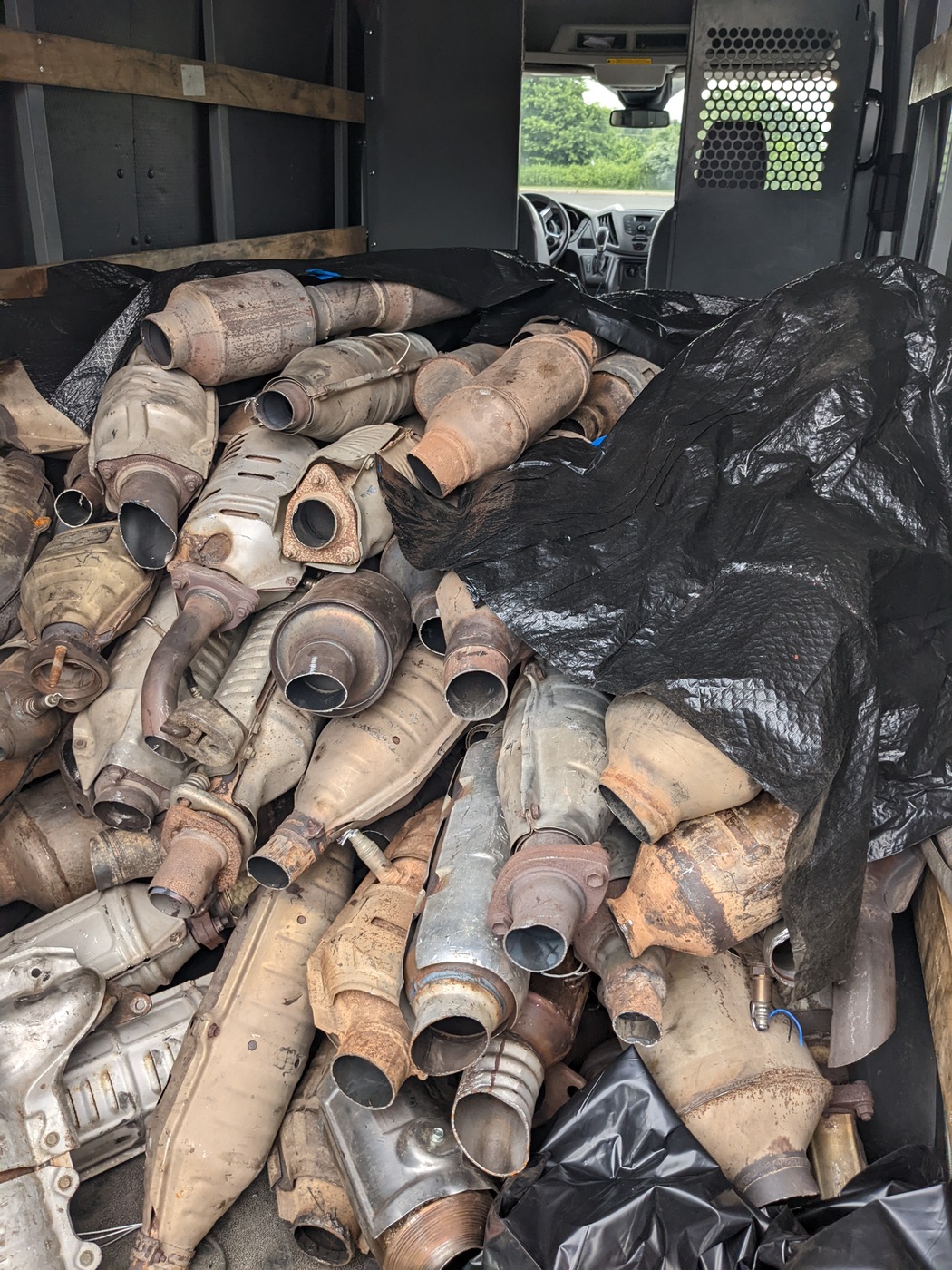 As part of a nationwide takedown, FBI agents collected thousands of catalytic converters from junk yards and cut them to make them appear stolen (pictured). They then offered them up for sale. At the time of the takedown, seizures, and arrests, one suspect had amassed multiple pallets of catalytic converters, which were first shipped to a refinery and eventually overseas for recycling purposes.