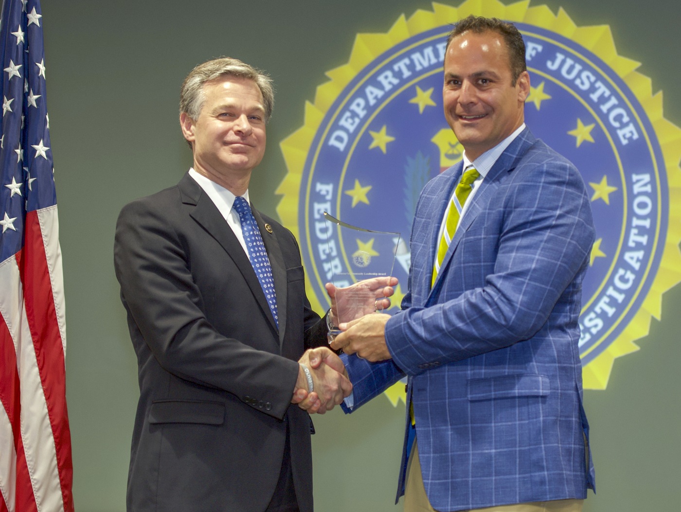FBI Director Christopher Wray presents Criminal Justice Information Services (CJIS) Division recipient Mark Urso with the Director’s Community Leadership Award (DCLA) at a ceremony at FBI Headquarters on May 3, 2019.