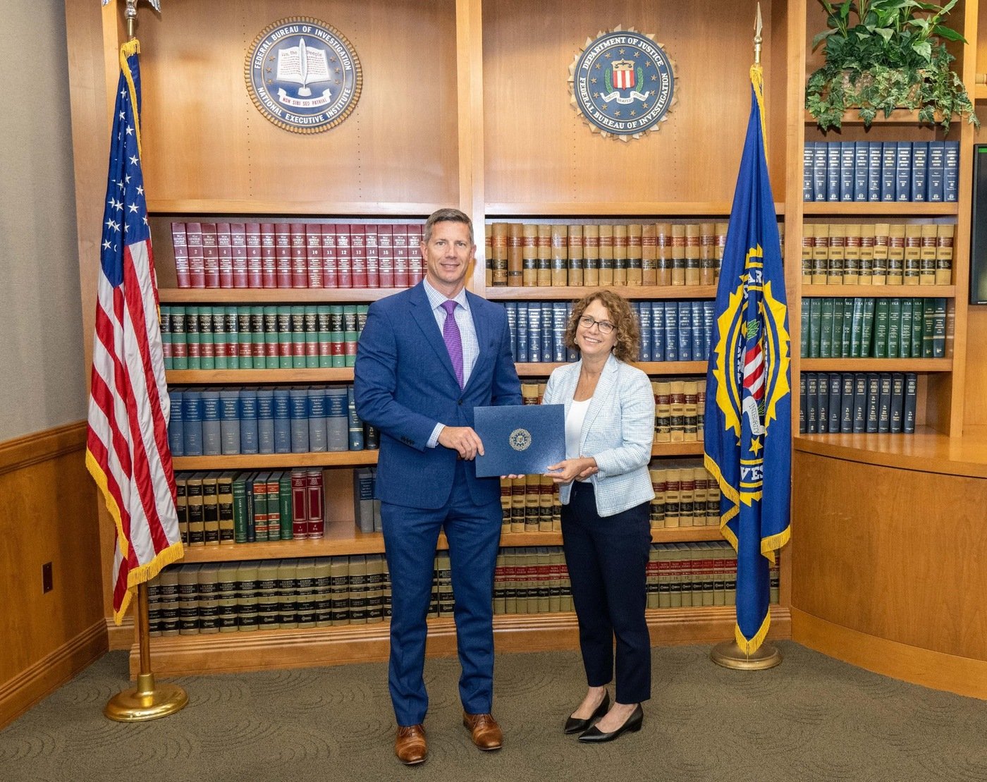 Cleveland Special Agent in Charge Eric B. Smith presents the 2021 FBI Director’s Community Leadership Award (DCLA) to Sheryl Harris, Director for the Cuyahoga County Department of Consumer Affairs.
