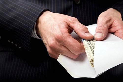 An image depicting a public official taking a bribe.
