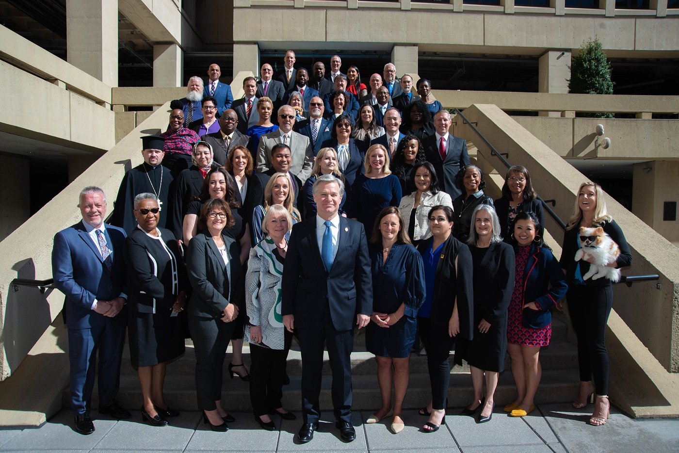 Director Christopher Wray joins recipients of the 2022 Director's Community Leadership Awards for a group photograph at FBI Headquarters on May 5, 2023.