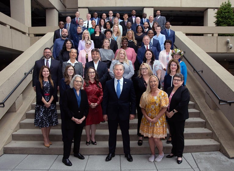 FBI Director Wray and the 2023 Director's Community Leadership Award recipients pose for a group photo at FBI Headquarters in Washington, D.C., on April 19, 2024.
