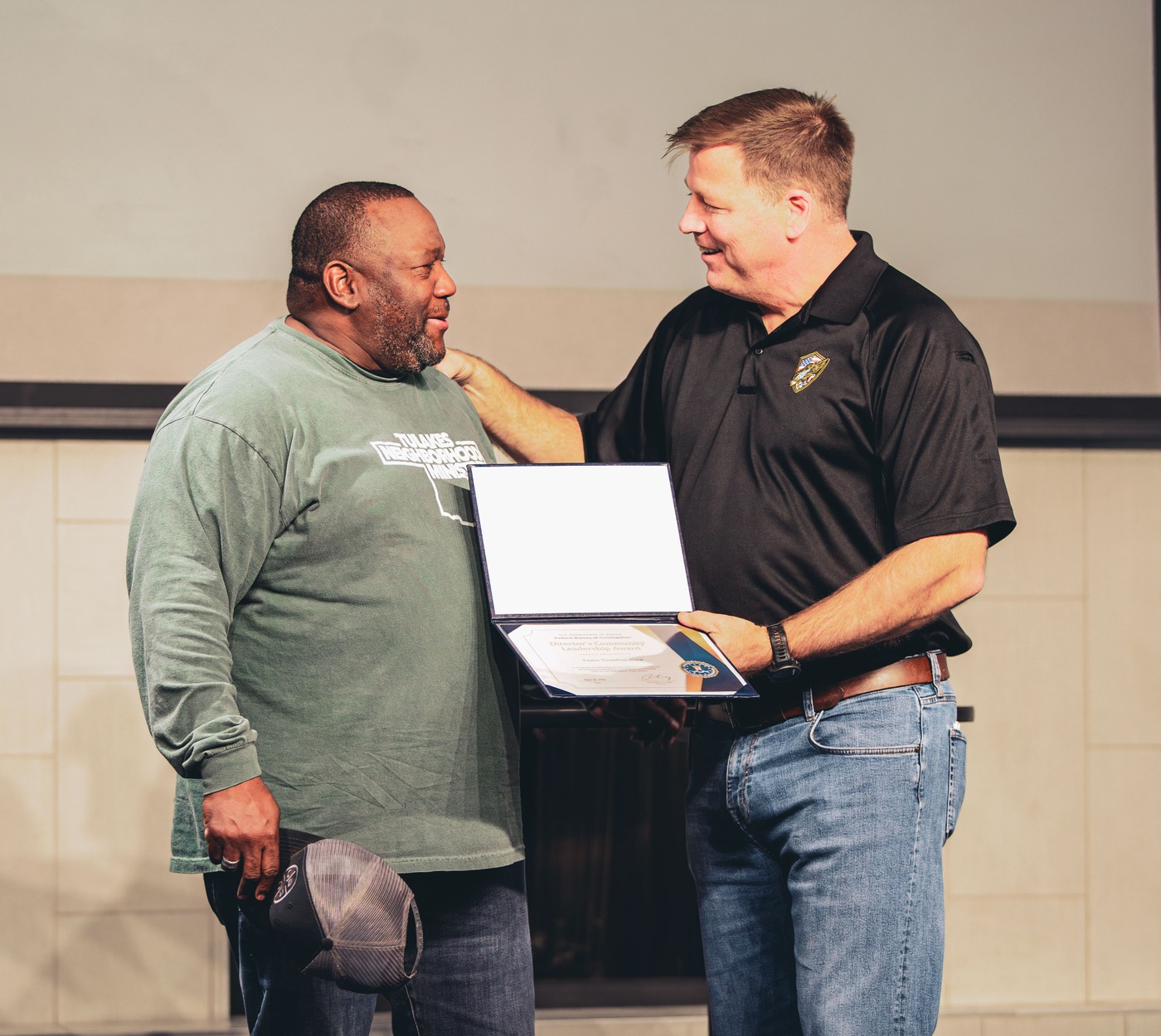 Oklahoma City SAC Edward Gray presents Thaddeus Black, pastor of Tulakes Community Church in Bethany, Oklahoma, with a certificate acknowledging he received FBI Oklahoma City's 2023 Director's Community Leadership Award. 