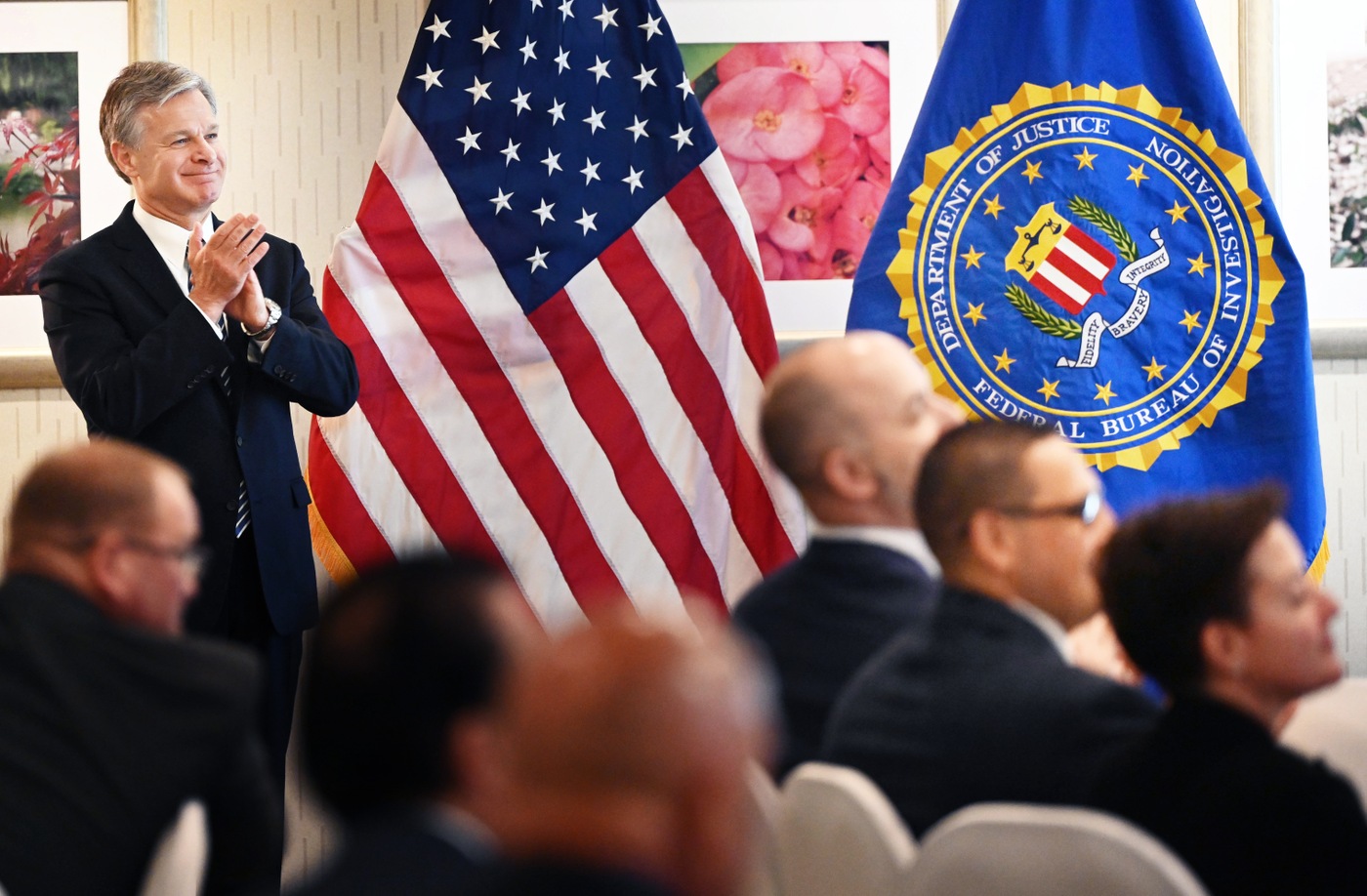 Director Christopher Wray applauds during an FBI National Command Course graduation ceremony held on July 14, 2023.