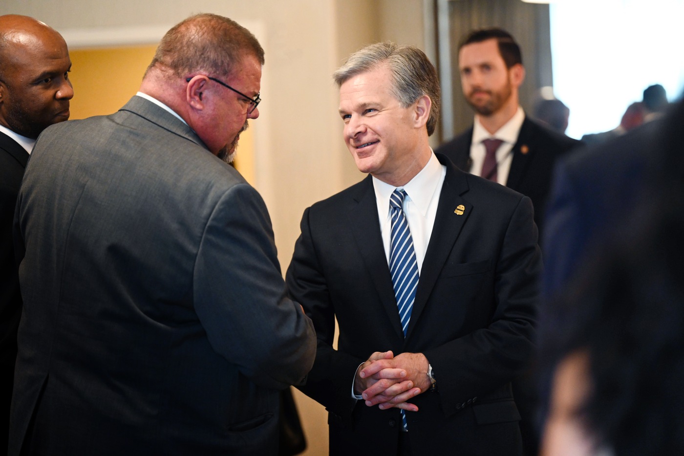 Director Christopher Wray speaks with a graduate of the FBI National Command Course on July 14, 2023.