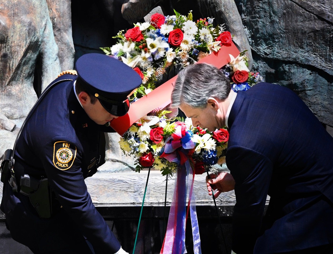 Photo of Director Wray laying a wreath for fallen FBI employees