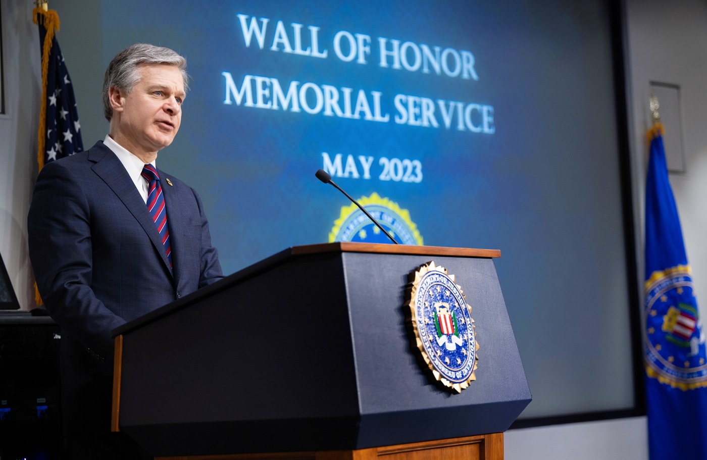FBI Director Christopher Wray speaks at a Wall of Honor Memorial Ceremony at FBI Headquarters on May 11, 2023. Two new names were added to the FBI's Wall of Honor: Supervisory Police Officer (Lt.) Yiu Tak "Louis" Tao and Supervisory Administrative Specialist Bryan A. Myers. Both died in 2022 from illnesses related to toxic air exposure during 9/11 recovery efforts.