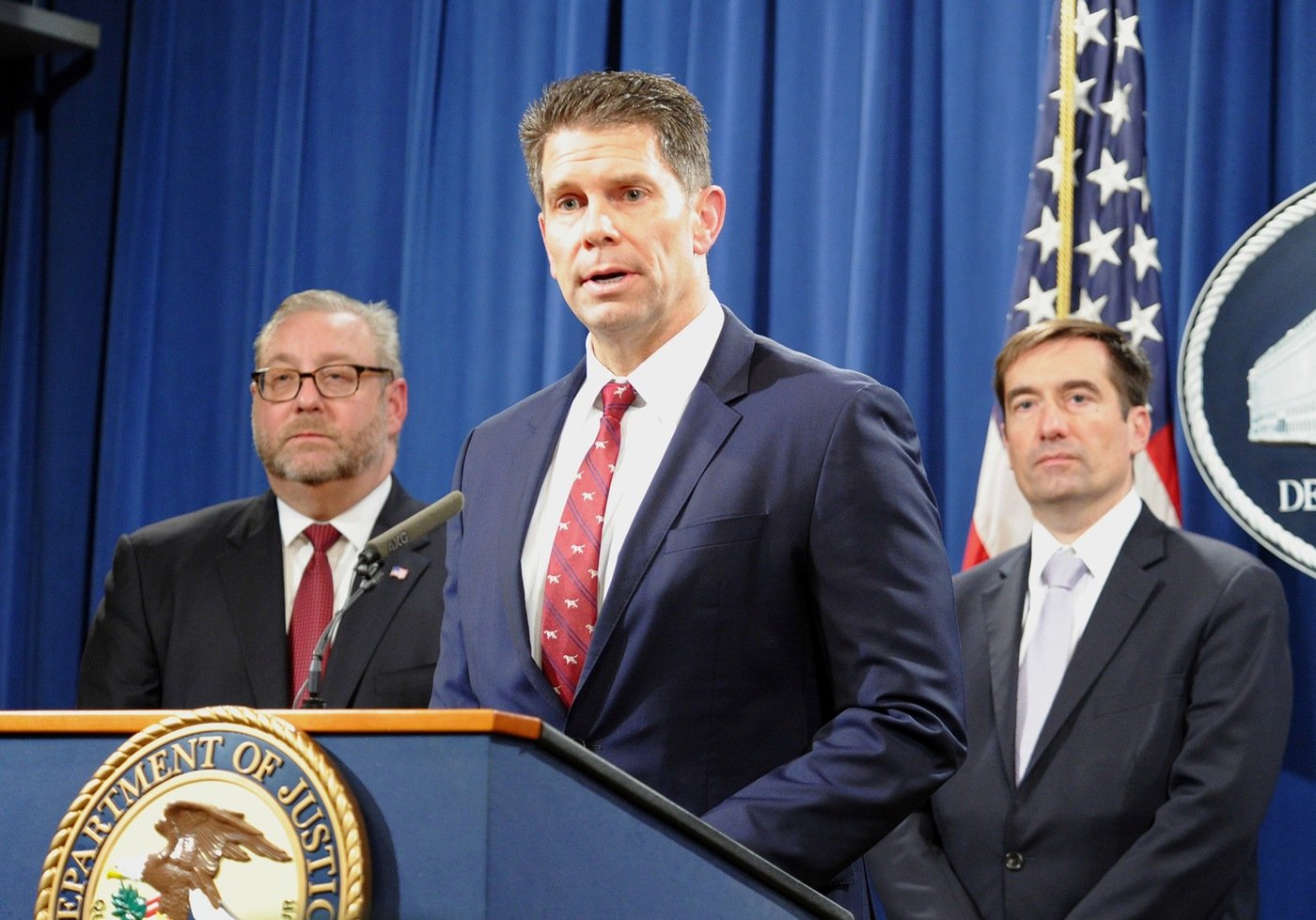 FBI Deputy Director David Bowdich answers questions during a press conference on countering Chinese economic espionage efforts. Standing behind Bowdich are Assistant Attorney General for the Criminal Division Brian A. Benczkowski and Assistant Attorney General for National Security John Demers.