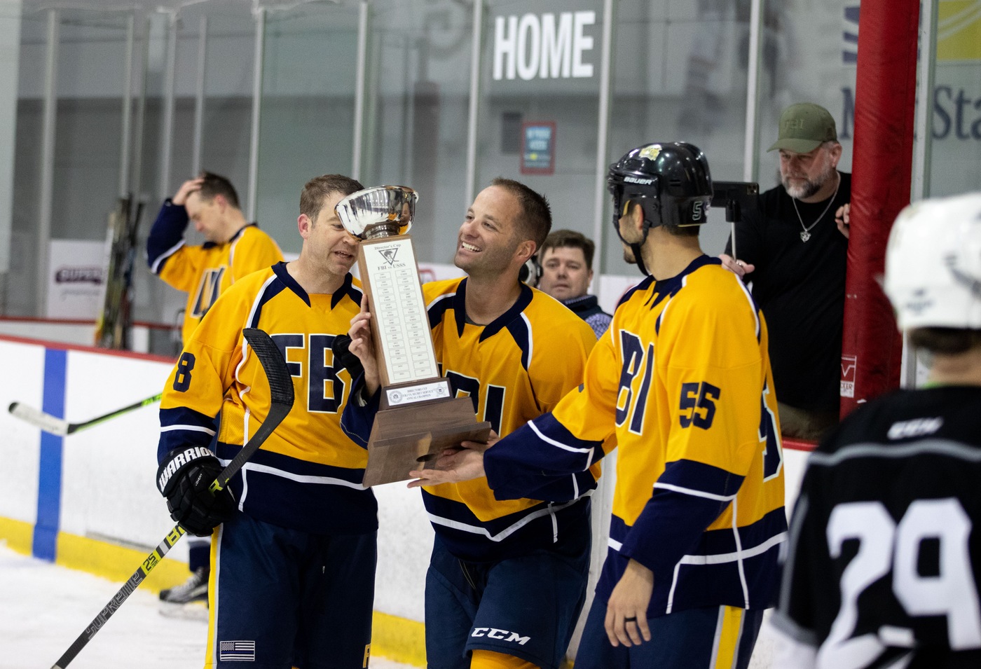 The FBI hockey team accepts a trophy after defeating the U.S. Secret Service team on April 30, 2022. 