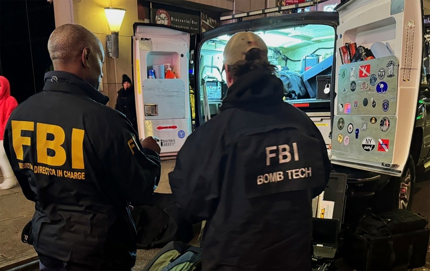 FBI New York Assistant Director in Charge Jim Smith checks in with one of the field office's special agent bomb technicians helping to keep New Year's Eve safe and secure on December 31, 2023.