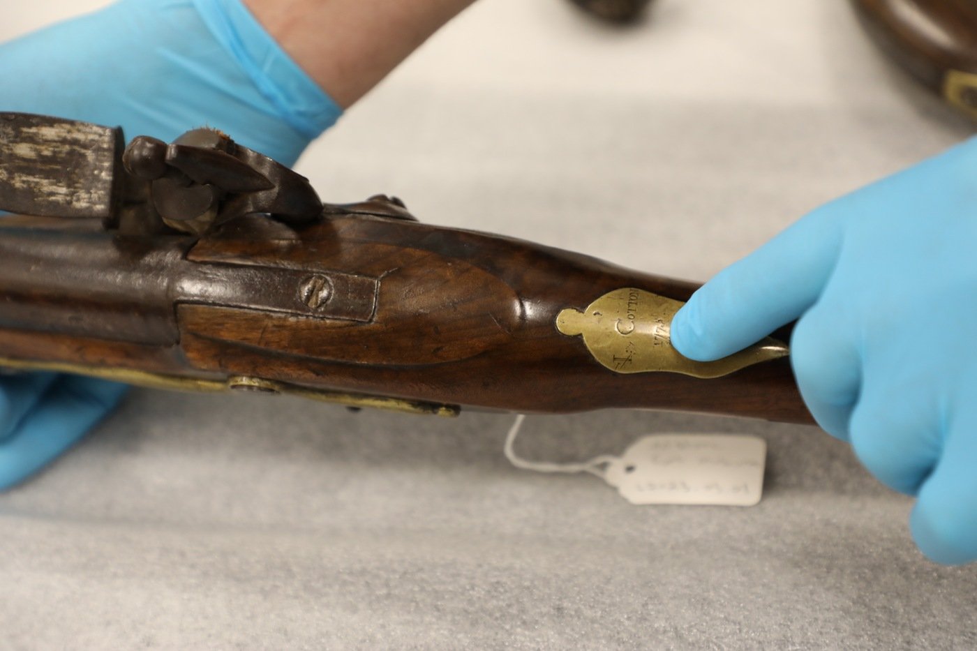A Museum of the American Revolution employee points out a detail of the brass inlay of a Revolutionary War-era musket that was recovered as part of a joint art crime investigation by FBI Philadelphia and our law enforcement partners, with significant assistance from the U.S. Attorney's Office for the Eastern District of Pennsylvania and the Museum of the American Revolution. A Massachusetts gunsmith manufactured the musket in 1775, and it was likely used in the earliest battles of the Revolutionary War.