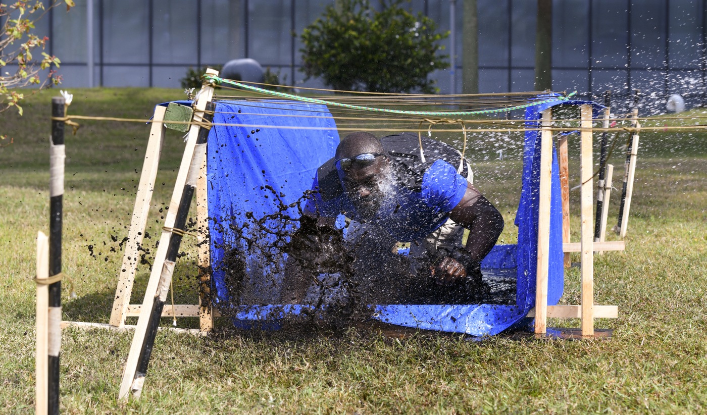 An FBI Miami employee participates in a mud run during a series of workouts on Feb. 4, 2022 to honor the memory of fallen Special Agents Daniel Alfin and Laura Schwartzenberger.