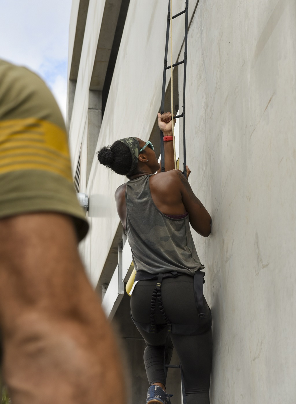 An FBI Miami employee climbs a rope during a series of workouts on Feb. 4, 2022 to honor the memory of fallen Special Agents Daniel Alfin and Laura Schwartzenberger.