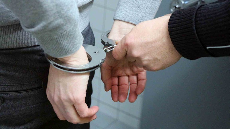 Handcuffs Behind Back (Stock Image)