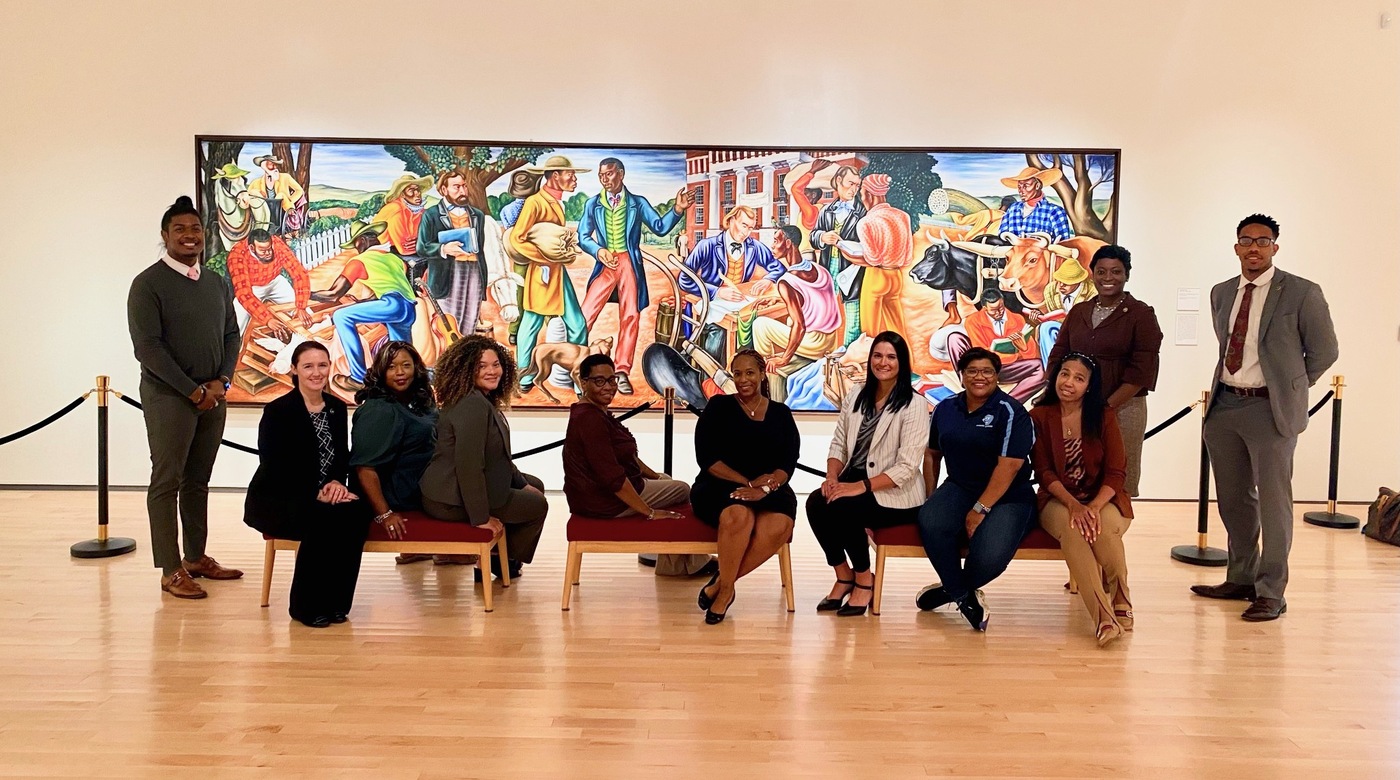 During the HBCU tour stop at Talladega College in Alabama, FBI employees and school staff gathered in the Dr. William R. Harvey Museum of Art in front of “First Day of Registration at Swayne Hall,” a mural painted by one of the college’s professors, Hale Woodruff, in the 1930s. 