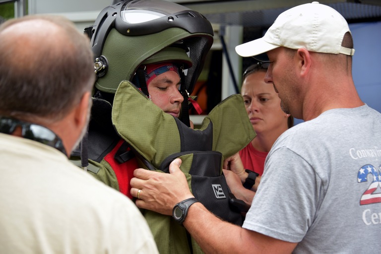 Students help Miami Police Department Detective Robert Rodriguez don a bomb suit before investigating a simulated threat at the FBI’s Hazardous Devices School at Redstone Arsenal in Huntsville, Alabama.