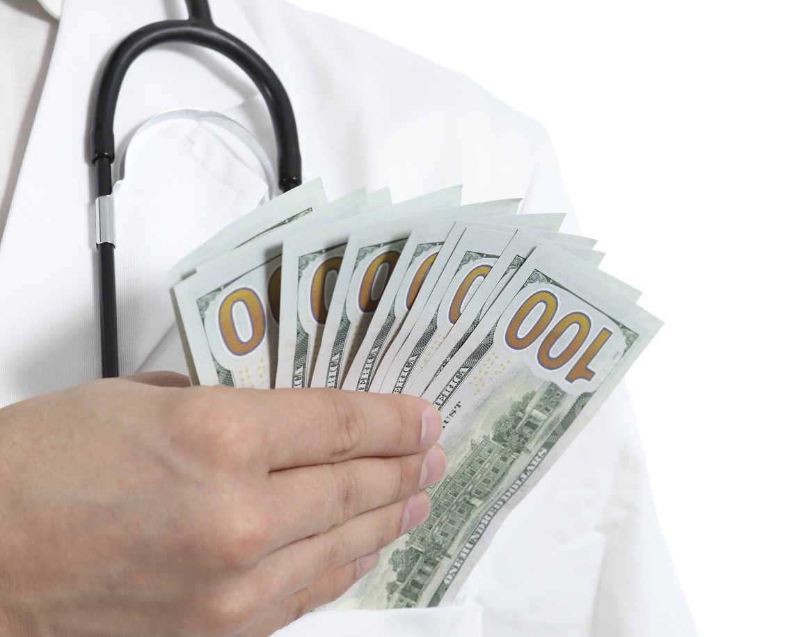 Medical Professional Holding Cash