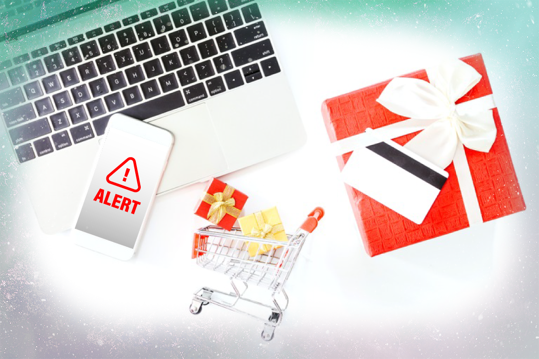 Stock graphic with keyboard, cell phone with a scam alert, shopping cart, gift box, and credit card