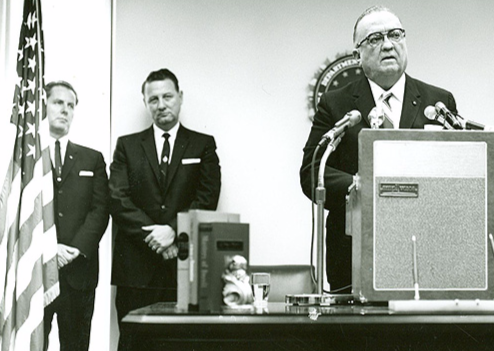 FBI Director J. Edgar Hoover speaks at the opening of the Jackson Division on July 10, 1964 as newly minted Jackson Special Agent in Charge Roy K. Moore (far left) and trusted Hoover adviser Special Agent Cartha "Deke" DeLoach look on.