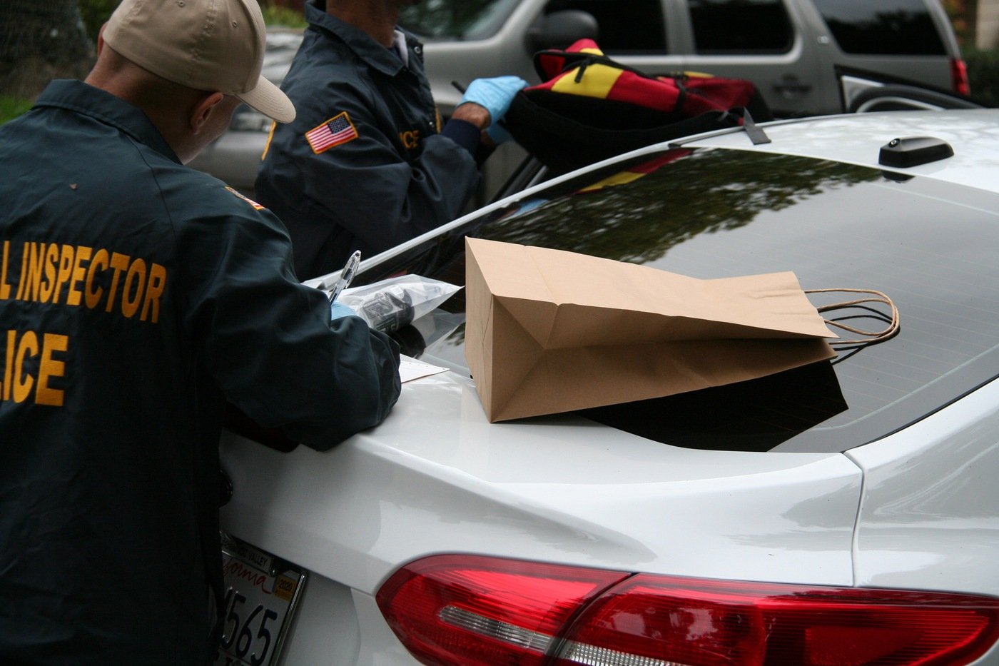 Members of the the Joint Criminal Opioid and Darknet Enforcement (J-CODE) team conduct a vehicle search in March 2019 in California as part of a Darknet drug investigation.