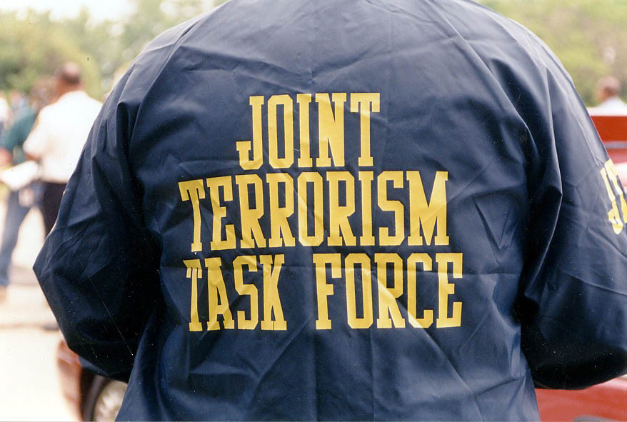 Investigator wearing at JTTF jacket at a scene.