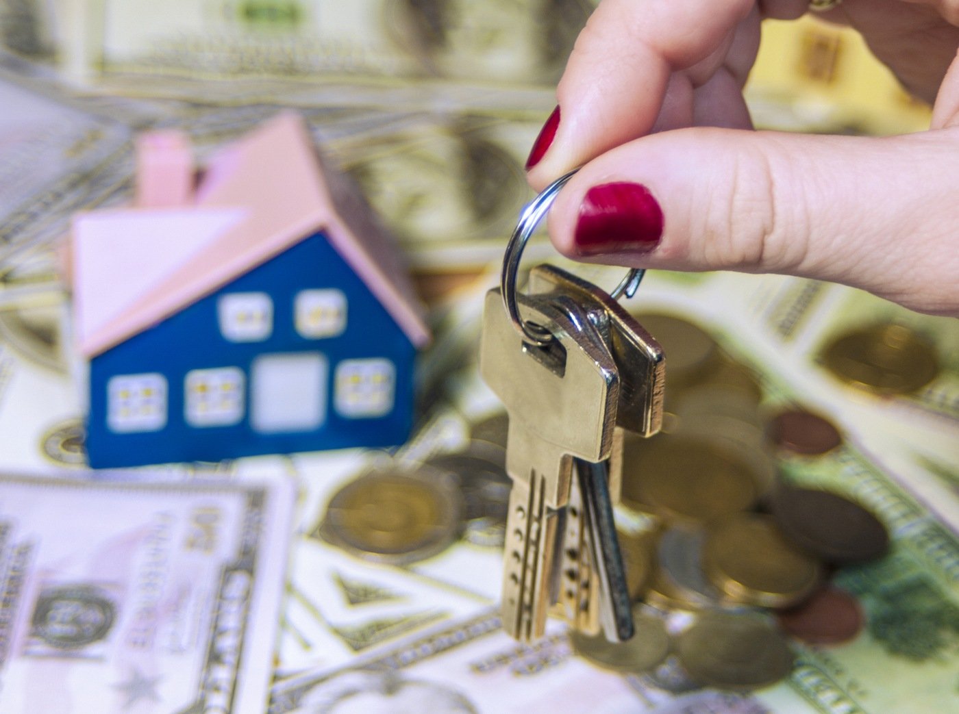Stock image depicting a person holding house keys. 