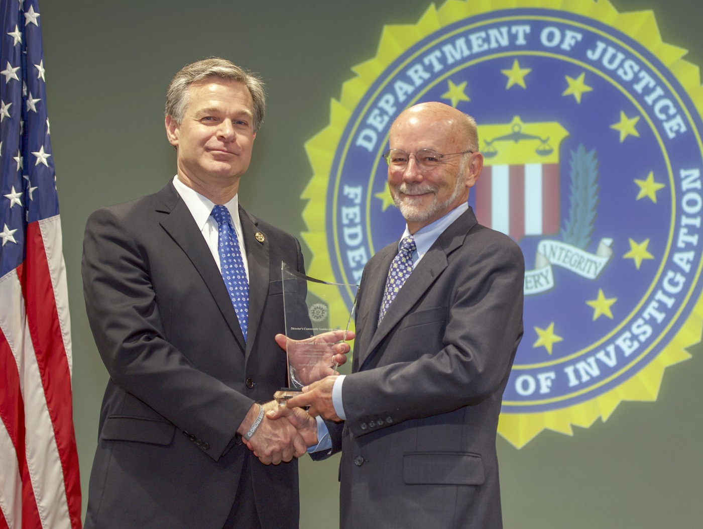 FBI Director Christopher Wray presents Knoxville Division recipient the Dollywood Foundation (represented by David Dotson) with the Director’s Community Leadership Award (DCLA) at a ceremony at FBI Headquarters on May 3, 2019.