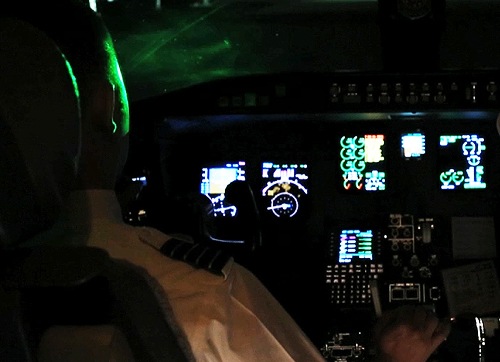 Pilot in Cockpit Being Lased