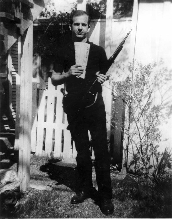 "Backyard photo" of Lee Harvey Oswald, assassin of U.S. President John F. Kennedy, holding two Marxist newspapers, The Militant and The Worker, and a Carcano rifle, with markings matching those on the rifle found in the Book Depository after the assassination.
