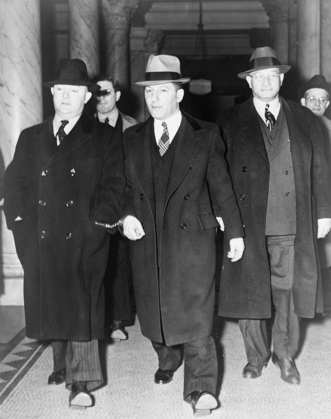 Mobster Louis "Lepke" Buchalter (center) is escorted from a courthouse in 1940. Library of Congress photograph.
