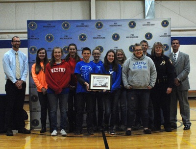 Eighth-grade students from Martin Luther School display FBI-SOS certificate with FBI and Oshkosh Police representatives.