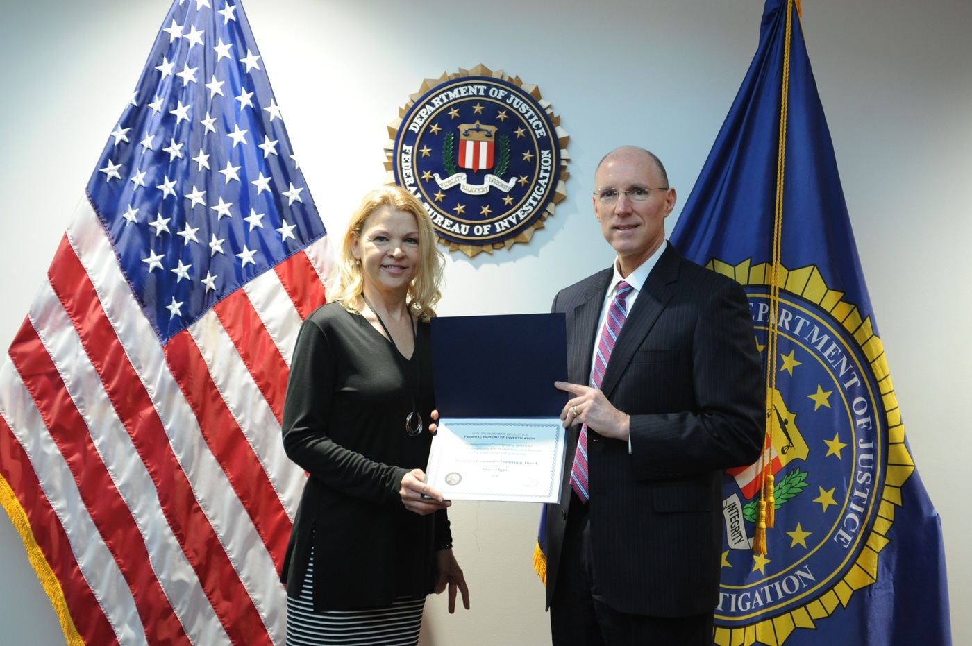 SAC Robert E. Hughes presents a DCLA certificate to Milwaukee recipient Theresa Kent. She will receive the DCLA award from FBI Director Christopher A. Wray in Washington, D.C. on May 1, 2020.