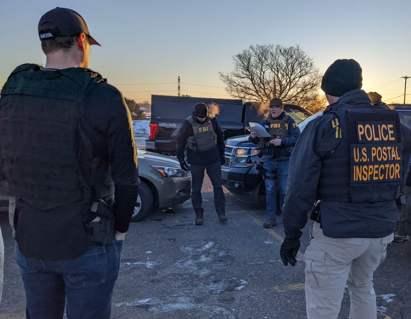 FBI agents, along with investigators from the IRS and the U.S. Postal Inspection Service, prepare to execute one of 25 search warrants carried out during the early morning of January 20, 2022, as part of the Feeding Our Future fraud investigation.