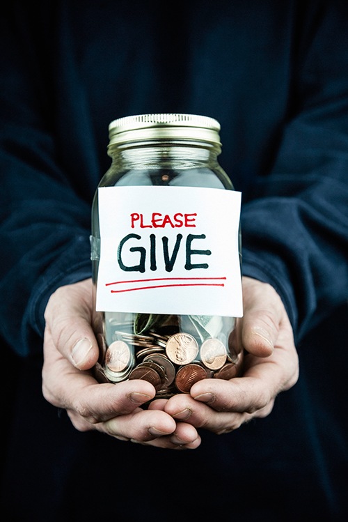 Money Collection in Donation Jar (Stock Image)