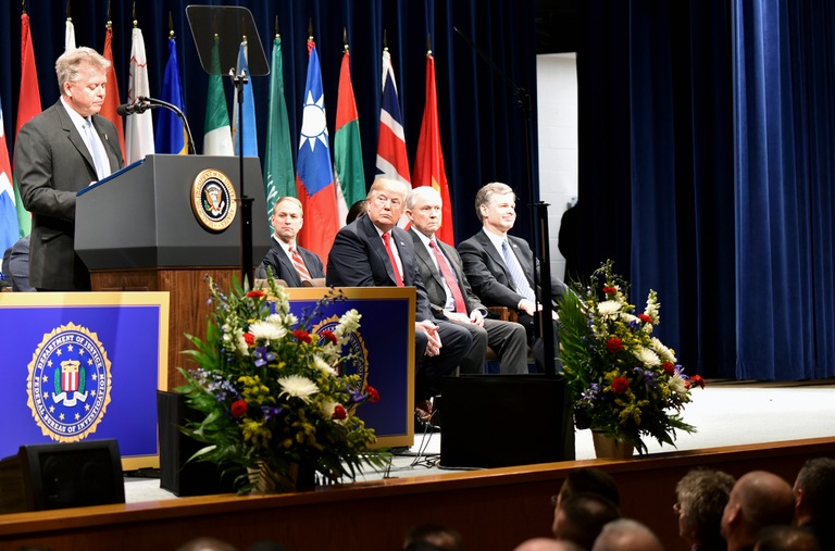 During a ceremony in Quantico, Virginia on December 15, 2017, class spokesperson Craig Wiles of the Drug Enforcement Administration addresses the graduates of the 270th session of the FBI National Academy as President Donald Trump, Attorney General Jeff Sessions, FBI Director Christopher Wray, and other officials look on.