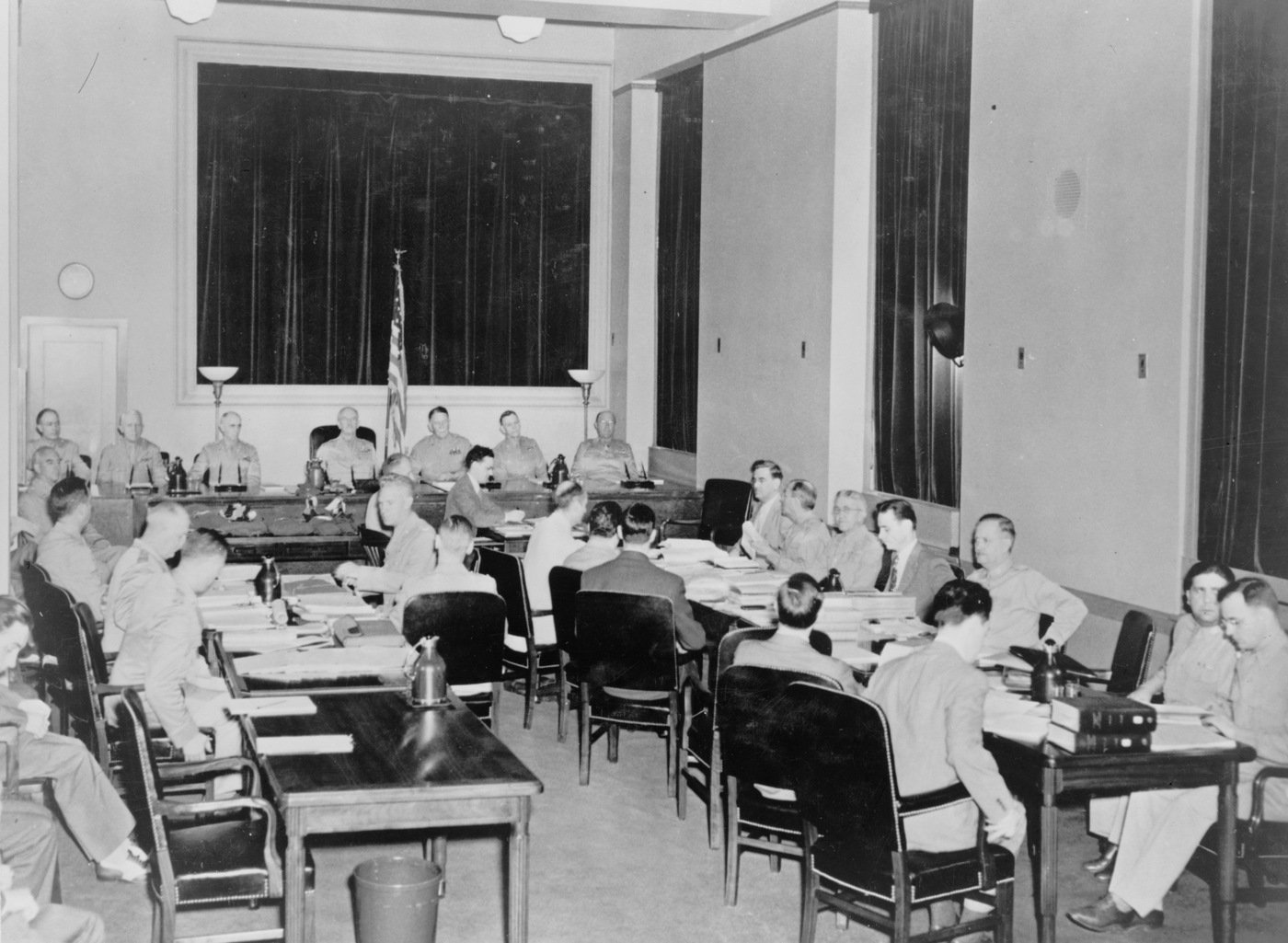 The special seven-man military commission opens the third day of its proceedings in the trial of eight Nazi saboteurs in the fifth floor courtroom of the Department of Justice building in July 1942. Sitting on the commission left to right are: Brigadier General John T. Lewis; Major General Lorenzo D. Casser; Major General Walter S. Grant; Major General Frank R. McCoy, president of the commission; Major General Blanton Winship; Brigadier General Guy V. Henry; and Brigadier General John T. Kennedy. All eight were found guilty. Library of Congress photograph. 
