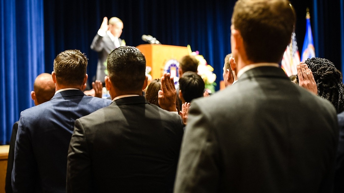 New agents take the oath of office before receiving their badge and credentials during a graduation ceremony at the FBI Academy in Quantico, Virginia.