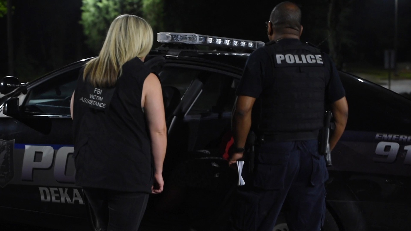 An FBI victim specialist and a DeKalb County (Atlanta) Police Department officer interview a woman in a police cruiser during Operation Independence Day, a monthlong nationwide operation to find human traffickers and rescue underage trafficking victims.