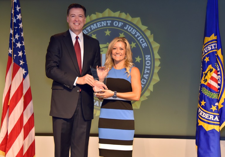 FBI Director James Comey presents Phoenix Division recipient Stephanie Siete with the Director’s Community Leadership Award (DCLA) at a ceremony at FBI Headquarters on April 28, 2017.