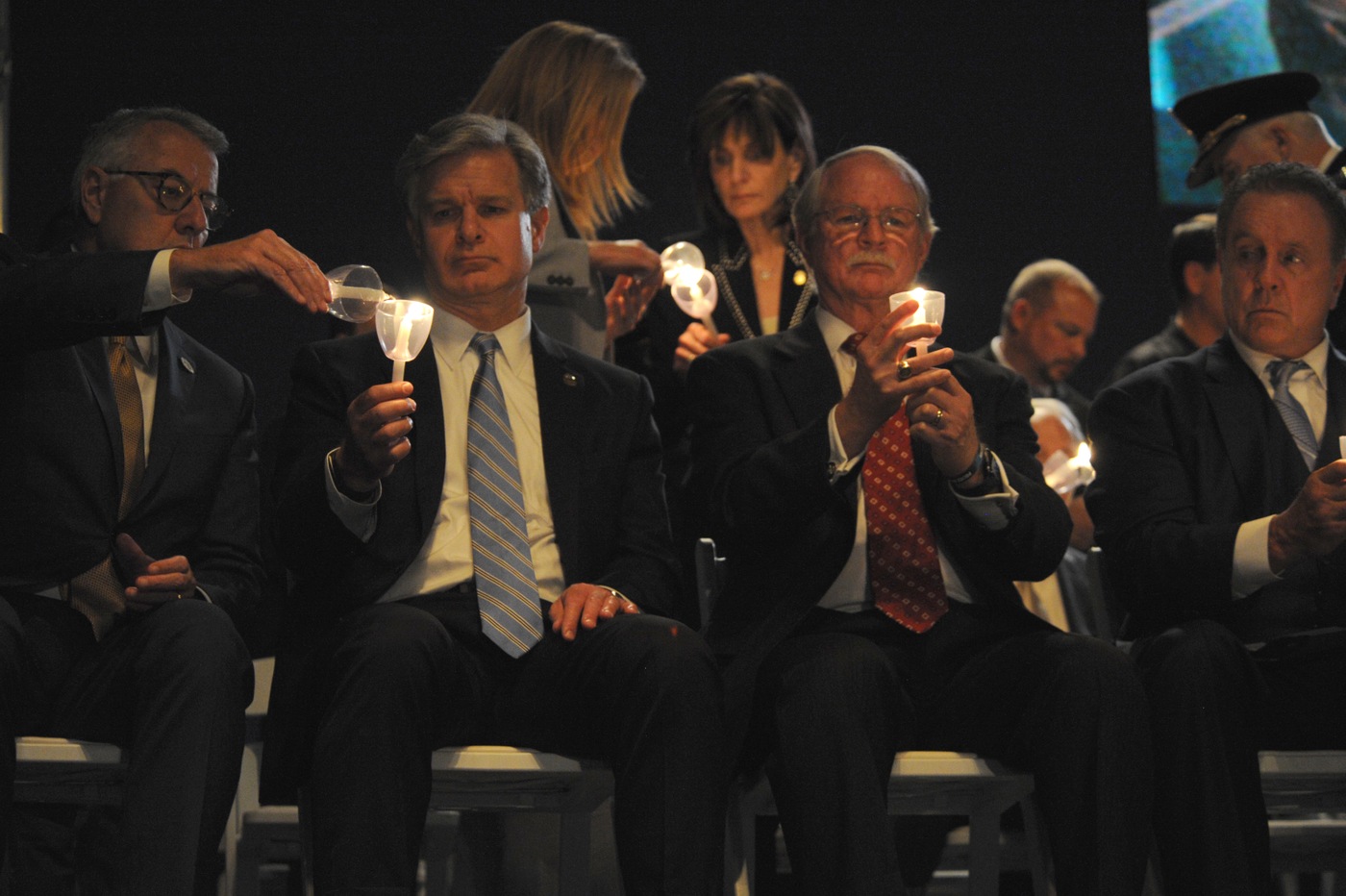 Director Christopher A. Wray lights a candle October 14, 2021, during a vigil in Washington, D.C. honoring fallen law enforcement during National Police Week.